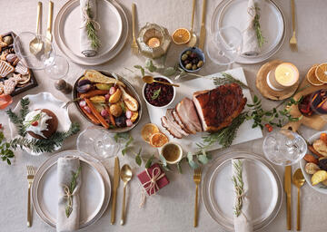 A holiday table with food and place settings