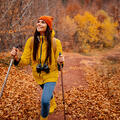 Female on a hike with walking sticks in Autumn