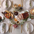 A holiday table with food and place settings